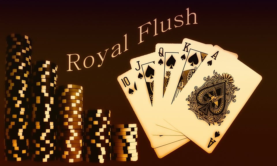 A hand of playing cards spread dramatically on green felt, representing the gamble of revolution